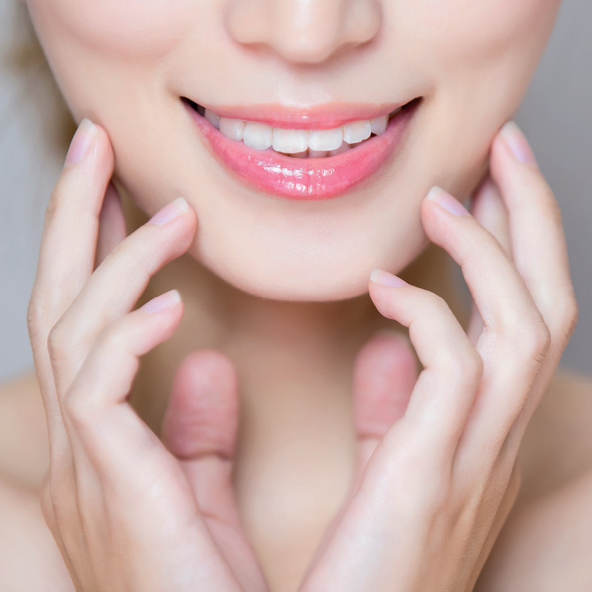 Beauty Science GOURI Skin Booster Woman touching smooth, firm skin on her jawline for GOURI skin booster treatment in Melbourne