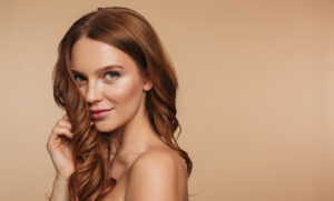 Melbourne's top hair and beauty trends showcased by a radiant woman with stunning red hair.