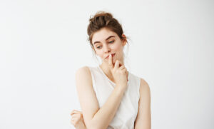Woman contemplating the shift from traditional body waxing to innovative skincare solutions.